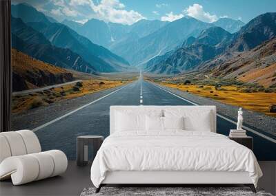 A long, empty road with a mountain range in the background Wall mural