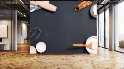 Baking background. Cooking ingredients for dough and pastry on black background Wall mural