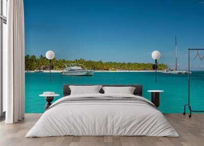 Seascape with crystal clear shallow turquoise ocean water, deep blue sky and white yachts and boats on the water surface. Saona Island, Dominican Republic. Wide angle shot. Wall mural