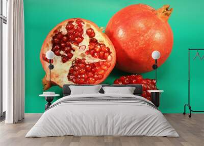 Pomegranate on a green background. Wall mural