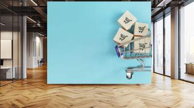 boxes in a shopping cart on blue background. concept: online shopping, e commerce and delivery of go Wall mural