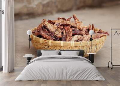 Dehydrated homemade pet beef lungs chips in straw pot on stone background. Dog and cat chewy jerky and treats. Outdoors, close up, soft selective focus, copy space. Wall mural