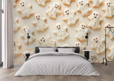 Delicious ghost shaped cookies covered with white icing for halloween lying on table Wall mural