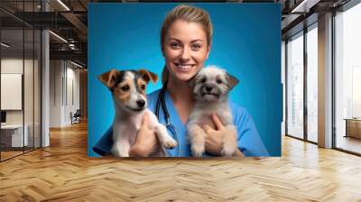 Doctor woman veterinarian in medical suit. holding two happy puppies in his arms Wall mural