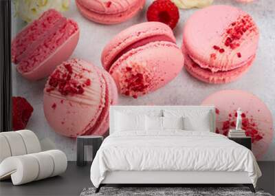 Feminine composition with traditional french macarons sweets and roses on light concrete background. Top view, close up. Wall mural