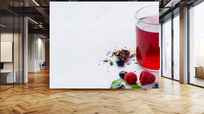 Summer fruit tea with mint in a glass cup, fresh berries, white background, copy space Wall mural