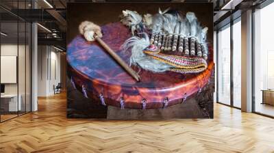 Feather headdress, ancient amerindian leather tambourine and drum drumstick. Attributes of the ancient american indian. Wall mural