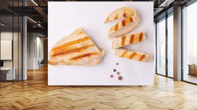 Grilled pieces of chicken breast on a white background. Grilled food with shadows, grilling season Wall mural