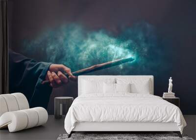 Hand in a black robe holding magical wooden wand Wall mural