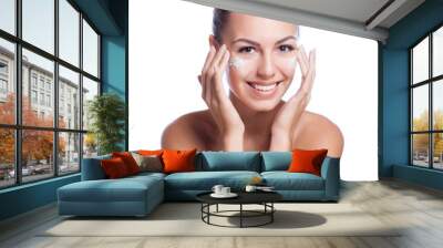 beautiful model applying cosmetic cream treatment on her face on white Wall mural