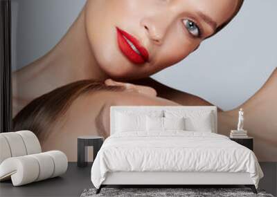 Beauty portrait of two women with red glamour make up. Red lips and red eyeshadows. Wall mural