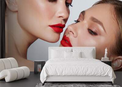 Beauty portrait of two women with red glamour make up. Red lips and red eyeshadows. Wall mural