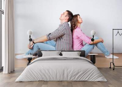 Couple sitting with their backs turned after having an argument Wall mural