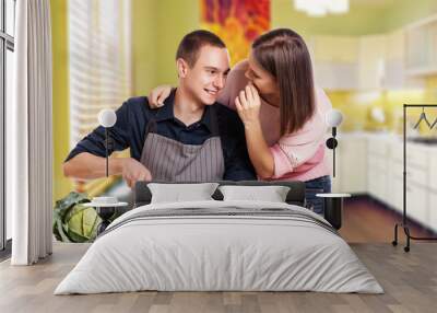 happy young couple have fun in modern kitchen indoor while prepa Wall mural