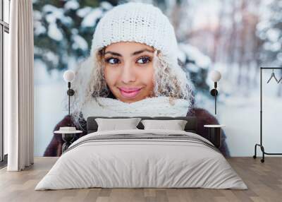 Close-up portrait of beautiful young afro american woman in winter forest Wall mural