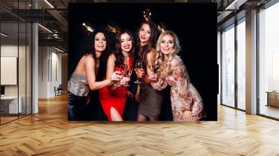 Four young beautiful women together celebrating party Wall mural