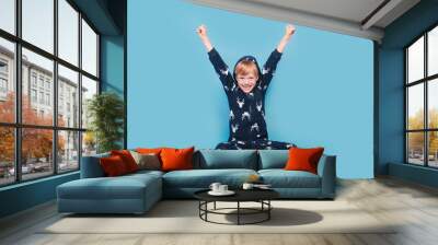 Happy little boy in warm pajamas waking up in the morning Wall mural