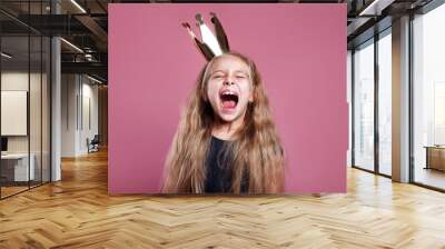 Shouting little girl in crown on pink background Wall mural