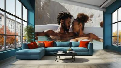 Lifestyle portrait of attractive black couple on honeymoon vacation relaxing in hot tub pool at luxury resort spa Wall mural