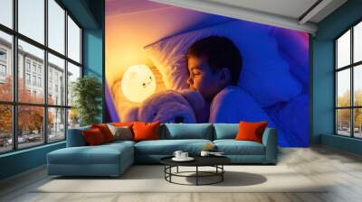 Little preschool kid boy sleeping in bed with colorful night led lamp. School child dreaming and holding plush toy. Kid angry of darkness. Wall mural