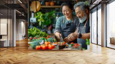 Lovely middle aged couple cooking vegetables together in the kitchen Wall mural