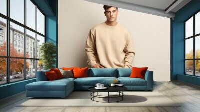 Male young model in beige blank sweatshirt, sweater on beige background. Clothes mockup. AI Generative Wall mural