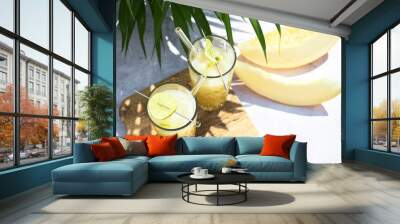 Refreshing melon smoothie with ice and lime in the sun. Summer cooling drinks. Wall mural