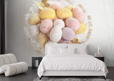 easter chocolate speckled eggs in bowl with paper batterfly on w Wall mural