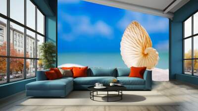 paper nautilus shell  on white  beach sand and blue seascape bac Wall mural