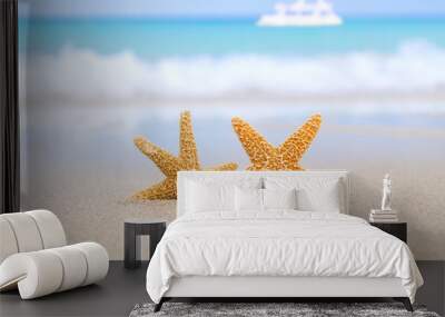 two starfish on beach, blue sea and white boat Wall mural