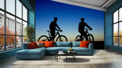 Two cyclists on the background of night sky and moon Wall mural