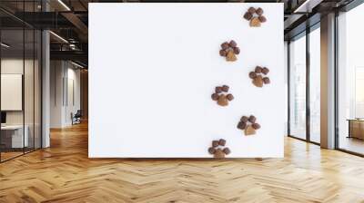 One side frame on the left is made of dry cat food in the shape of paws on a white background.flat lay.copy space.Pet store poster design.The concept of proper nutrition for Pets.Minimalistic pattern Wall mural