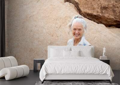 Senior Woman in the desert expressing wellness and heath.  Wall mural