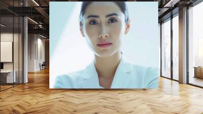 Studio portrait headshot of young professional Asian woman wearing white suit, boss lady concept Wall mural