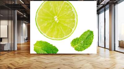 Top view of cross section of refreshing sour juicy lime slice and two fresh aromatic green mint leaves isolated on white background used as ingredient in mojito cocktail and lemonade healthy drink Wall mural