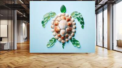 Turtle art from beach materials, orange white ridged seashell as shell, green sea glass for limbs, light blue plain background, unique nature inspired concept, beach decor, Wall mural