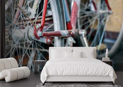 Two old dusty bicycles standing in closet under the stairs. Close up wheel, spokes, transmission chain and pedals. Copy space. Wall mural