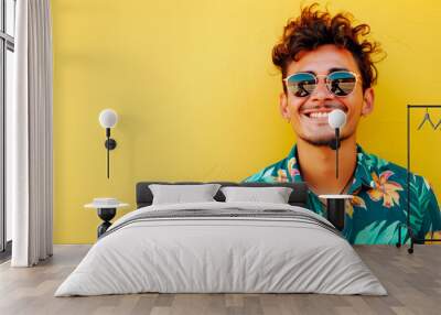 Summer fashion portrait of young man wearing hawaiian shirt over yellow background. Colourful summer style portrait with empty space for text or product presentation. Wall mural