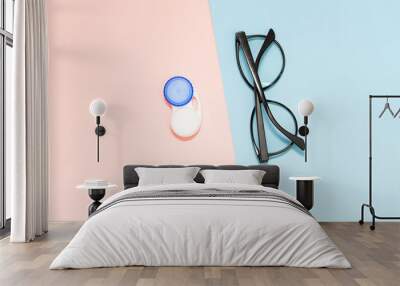 Glasses and contact lenses on two color pastel background, vision concept Wall mural