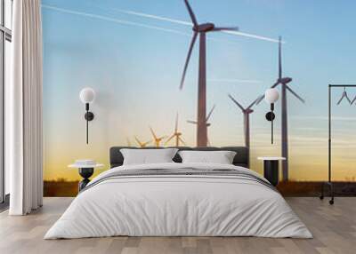 Wind Turbines at Dusk. Landscape sunset with windmills. Renewal source of electricity. Wind turbines field new technology for clean energy on mountain, sunset view with colorful twilight on sky Wall mural