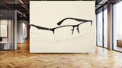 Women's glasses. Made of medical glass. Beautiful shape. On a white isolated background. Fashionable summer accessories for vision. Protect face and eyes from sun rays. Space for text. Close-up. Wall mural