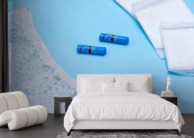 womens white panties tampons, pads  on a blue background Wall mural