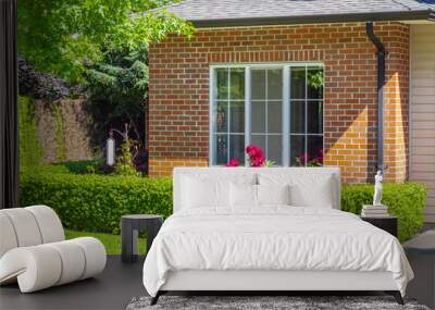 Facade with window of a brick house with a patio on a bright, sunny day in Vancouver, Canada House front door Wall mural