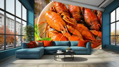 Boiled crawfish, lemon and parsley on a wooden table. Appetizer protein, the concept of healthy eating. Wall mural