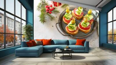 Creative appetizers christmas. Christmas tree canapes of salami, cheese, olives, tomatoes and cucumbers on a baguette. Copy space. Wall mural