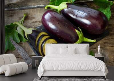 fresh healthy raw purple eggplant on a kitchen wooden table. the concept of diet menu. Wall mural