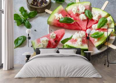 Healthy seasonal dieting and nutrition, summer snack. Watermelon pizza with feta cheese and basil on a gray stone tabletop. Wall mural