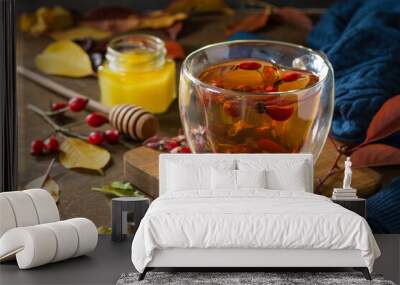 Healthy winter vitamin drink. Hot rosehip tea with honey and dried fruits on a wooden table top. Wall mural