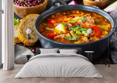 Homemade Meat Tomato soup close-up with beef and bean stew, vegetables on a stone tabletop. Wall mural