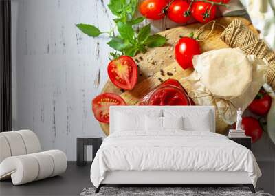 Tomato paste, home preservation. Tomato sauce made from ripe tomatoes on a wooden tabletop. Top view flat lay background. Copy space. Wall mural